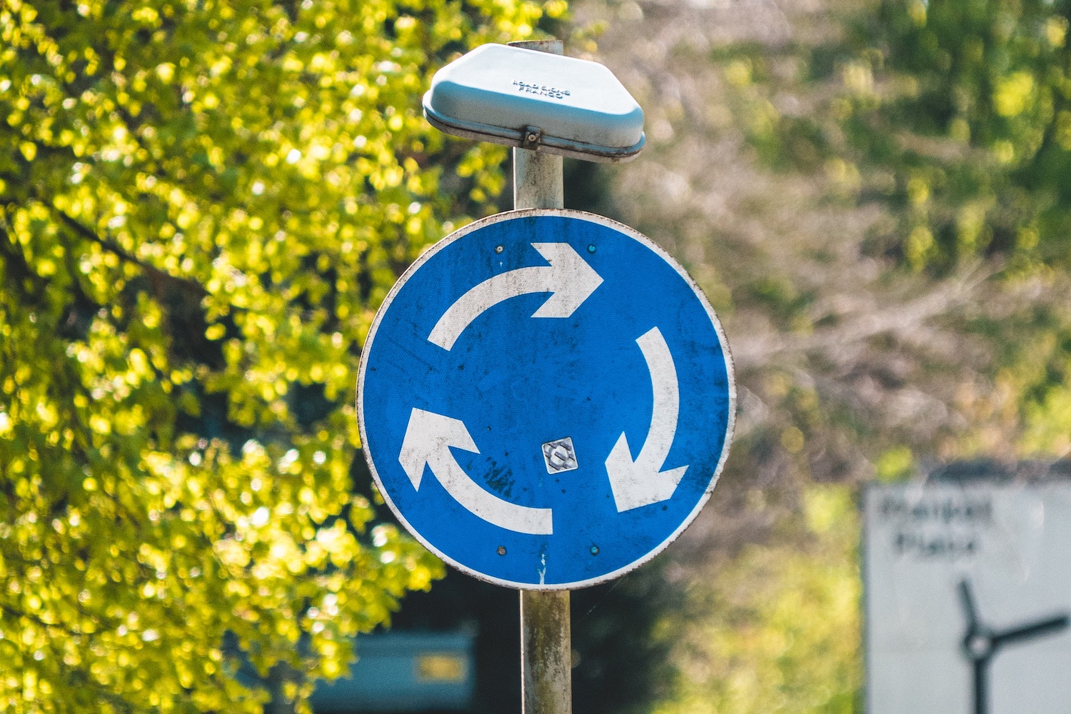 a blue and white street sign